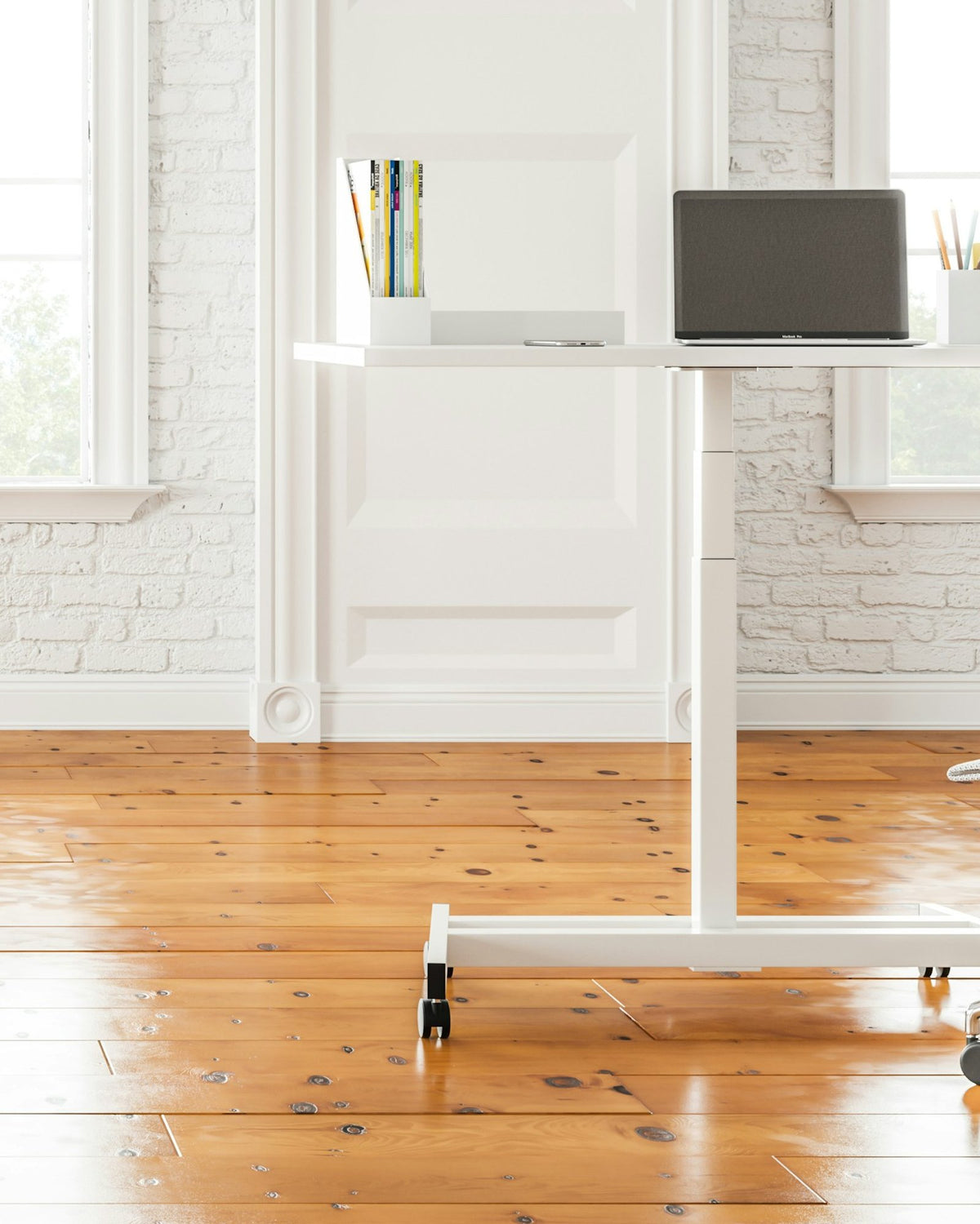 Bright white room with a small standing desk and a mesh office chair on a wooden floor