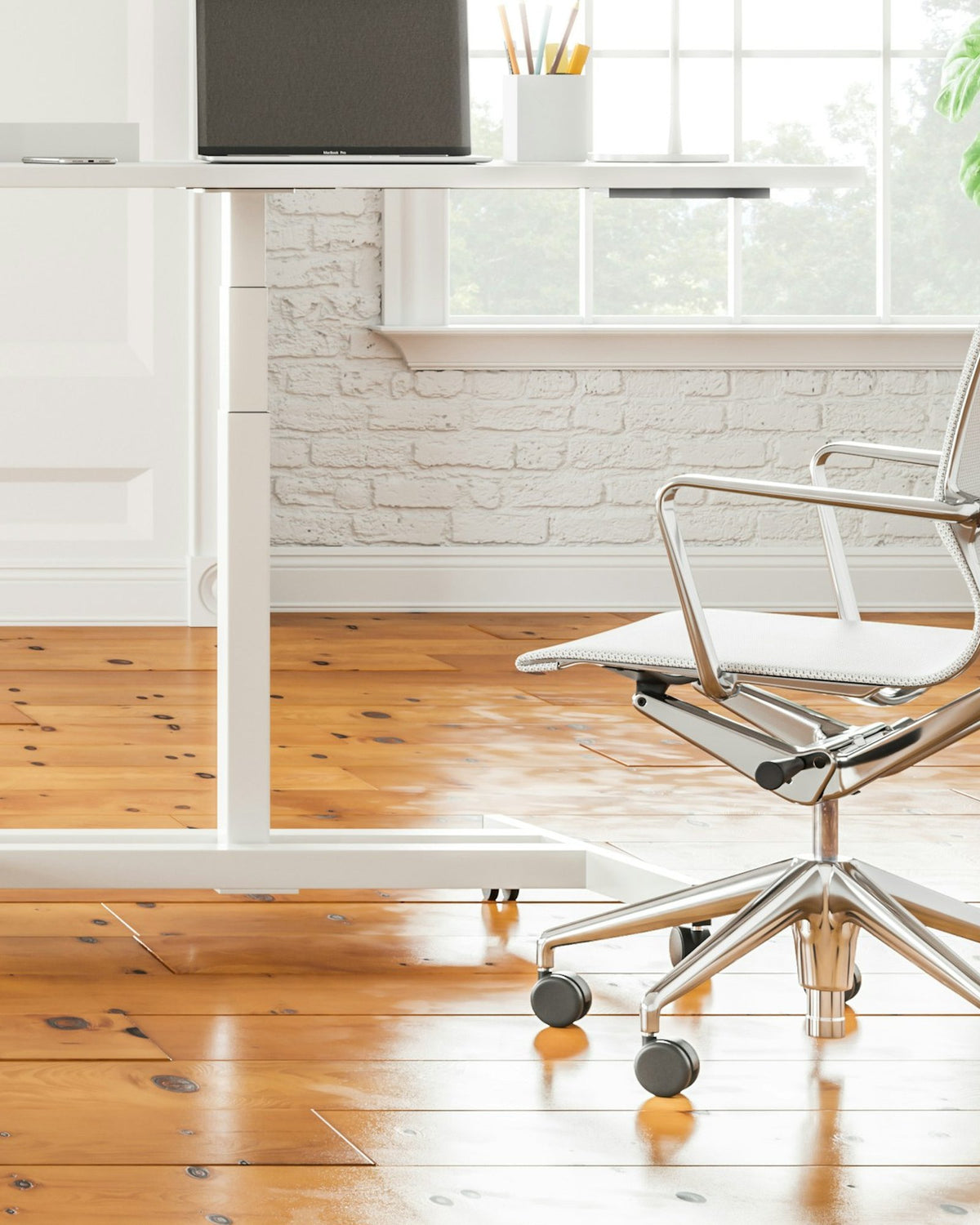 Bright white room with a small standing desk and a mesh office chair on a wooden floor